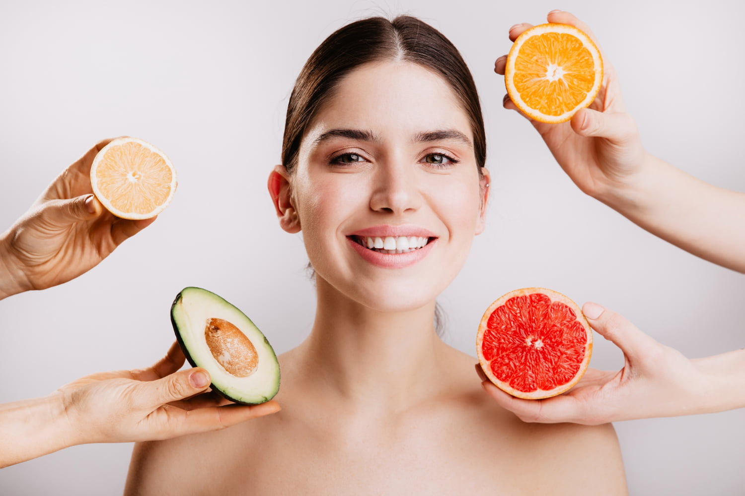 Colorful assortment of fruits, including avocados, berries, and citrus, arranged beautifully to highlight their benefits for glowing skin.