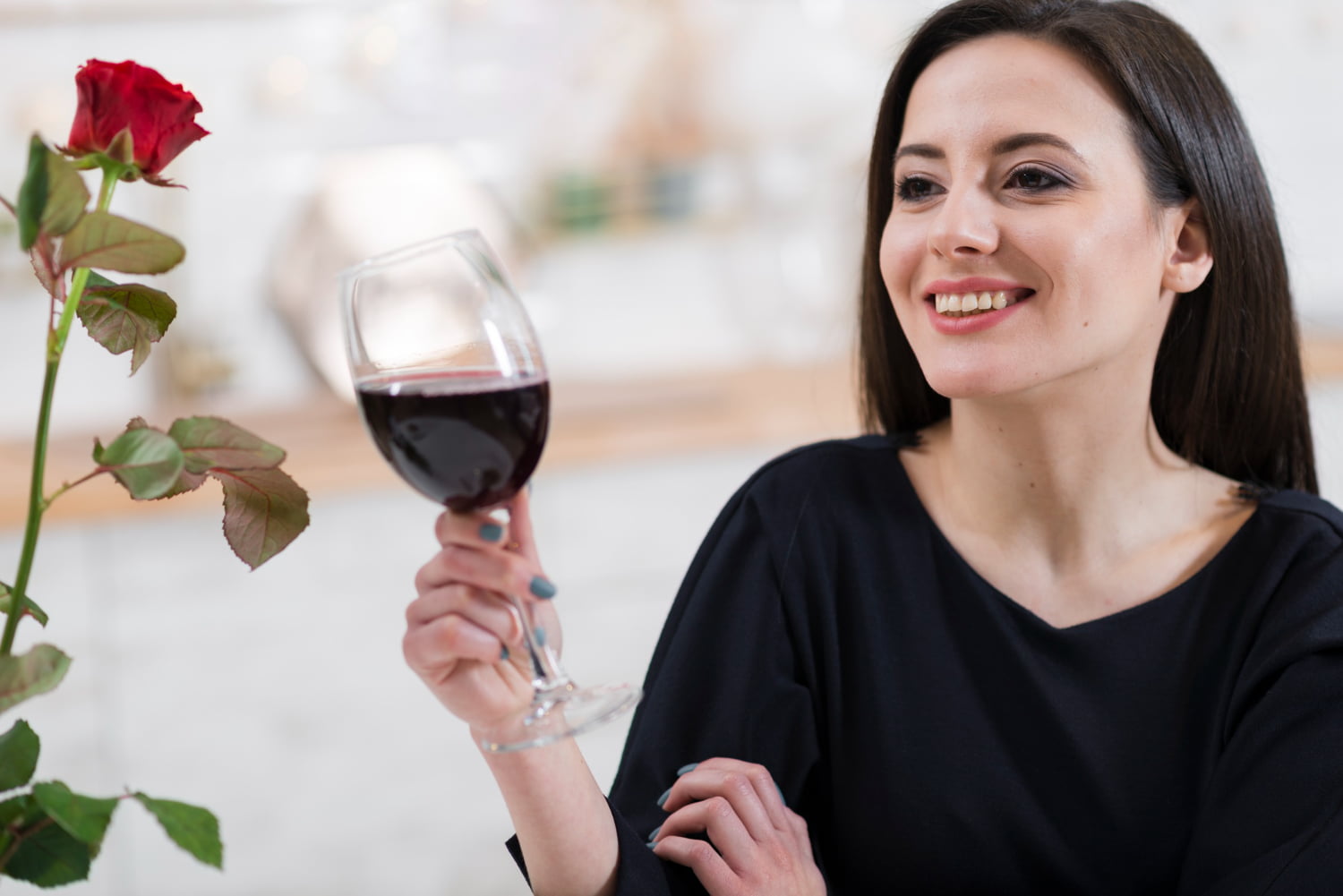 Is Wine Good for Skin? Discover the 3 Surprising Benefits 1 Woman holding a glass of red wine, representing relaxation and enjoyment in skincare and wellness.