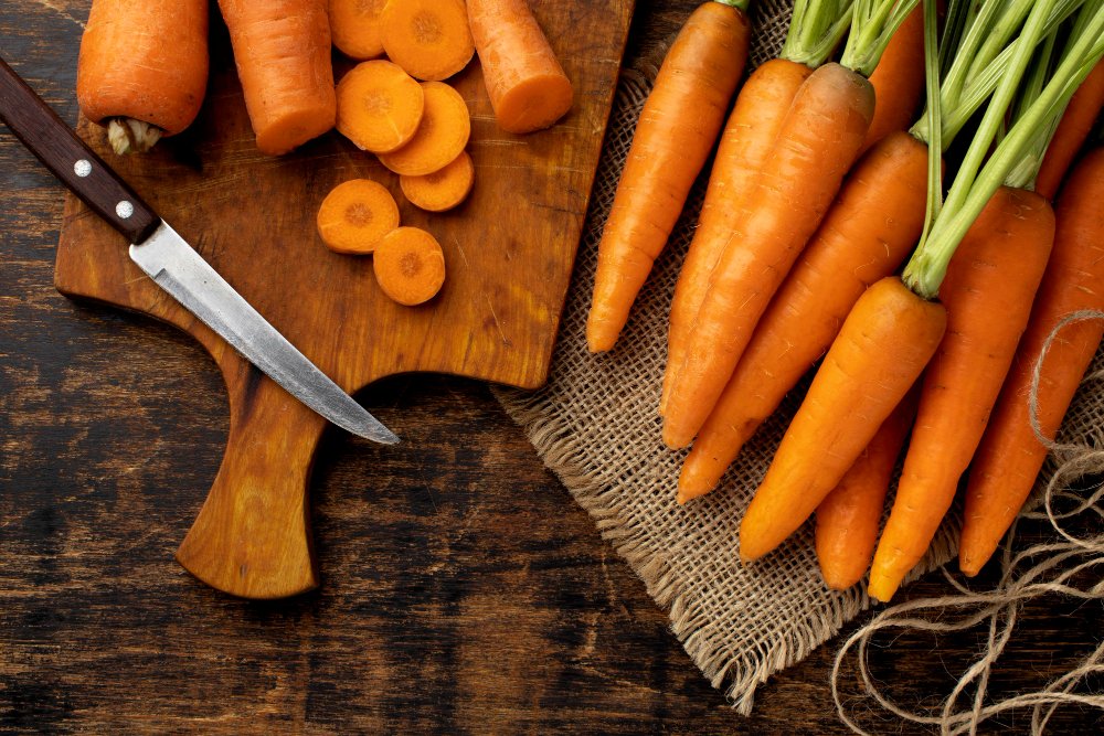 Which Food Is Good for Eyes: Nourish Your Healthy Vision 3 Fresh carrots on a cutting board, highlighting foods that are good for eyes, rich in beta-carotene and Vitamin A.