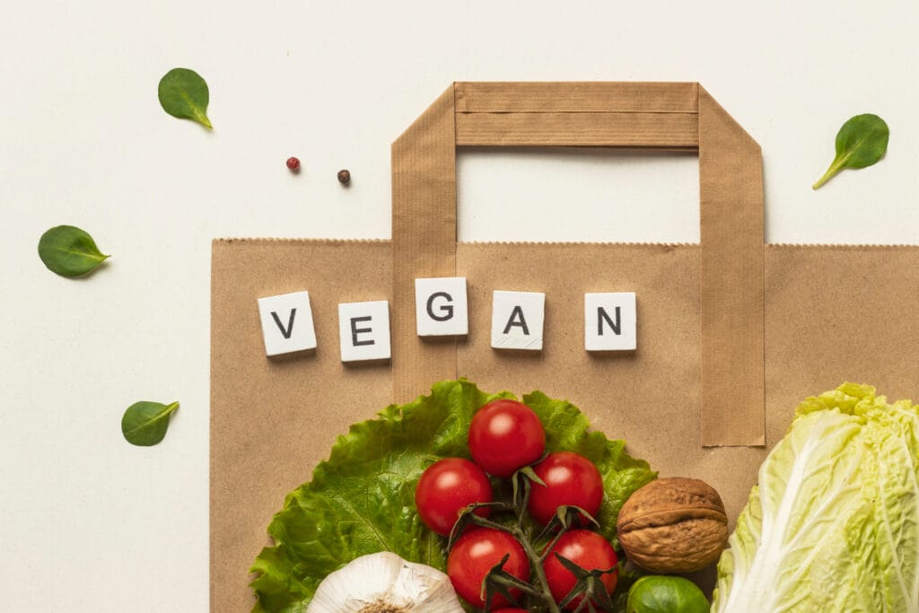 Vegan Diet Myths: 7 Surprising Truths for Better Nutrition 2 Vegan written alongside a variety of colorful vegan foods, showcasing delicious options for a balanced vegan diet.
