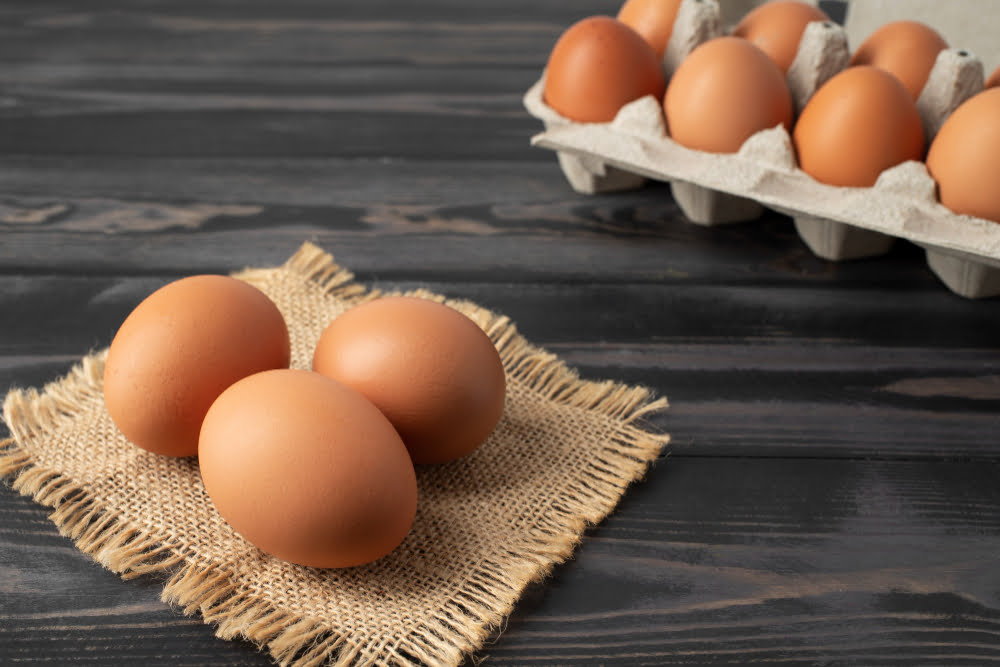 Which Food Is Good for Eyes: Nourish Your Healthy Vision 6 A crate of eggs on a table, illustrating foods that are good for eyes, providing lutein, zeaxanthin, and zinc.