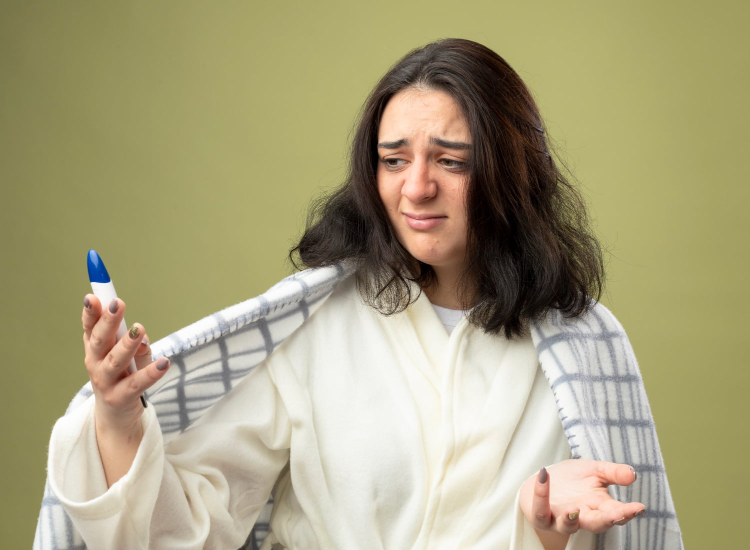Is It Safe to Take Medicine for Fever That Just Started? 1 Woman holding a thermometer indicating a newly started fever, illustrating the experience of illness and the need for medication.