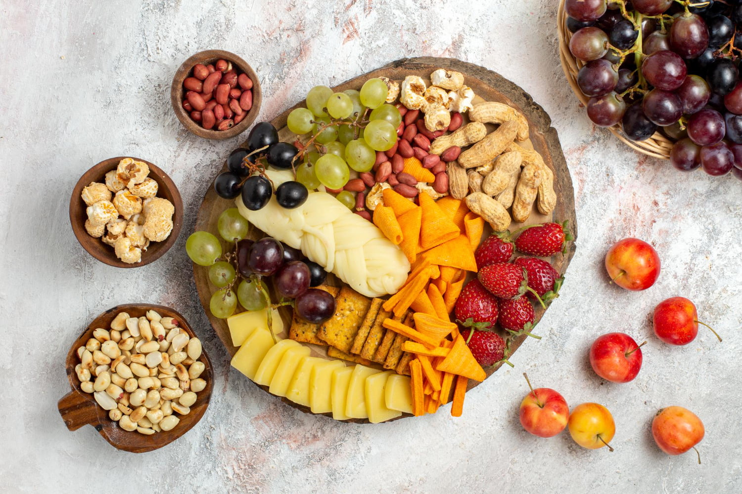 Collage of healthy snacks: Greek yogurt with fruit, veggie sticks with hummus, apple slices with nut butter, and a bowl of nuts and seeds. Healthy snack ideas for busy professionals.