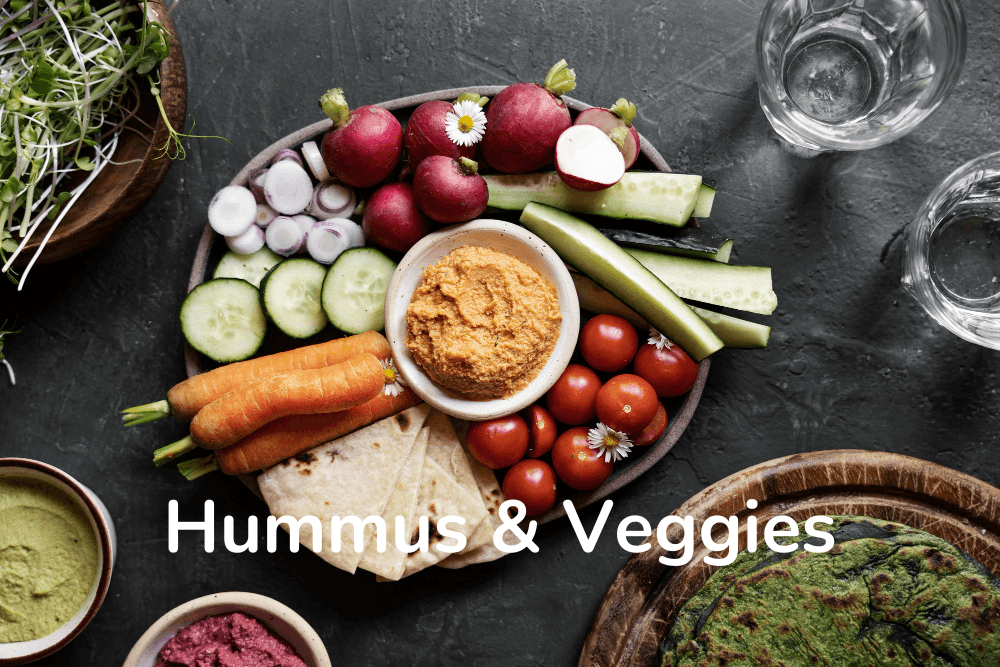 Colorful veggies served with creamy hummus for a tasty plant-based snack.