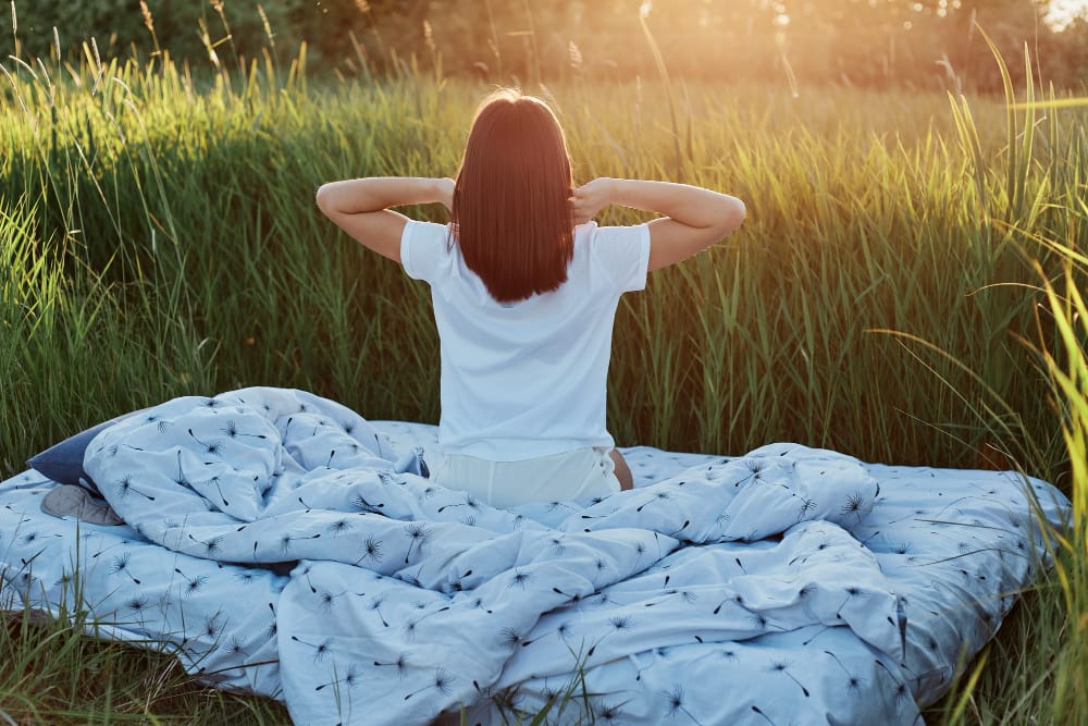 A woman waking up in a peaceful morning setting, starting her day with simple healthy habits to improve focus and boost mood.